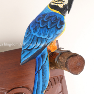 This Wooden Macaw Parrot Wall Mount is hand carved from wood and hand-painted in vivid blue, yellow, and orange colors, capturing the detailed feather patterns of a macaw. The bird is mounted on a small wooden perch, ready to be fixed on your wall as a striking decor piece. This piece makes a beautiful and eye-catching addition to your living room, entryway, or balcony wall, and also makes a thoughtful gift for bird and nature lovers. Since it is handmade and hand-painted, each piece may have slight differences in color and detail, adding to its charm. Care Tip: Keep away from water and direct sunlight to protect the paint and wood finish.