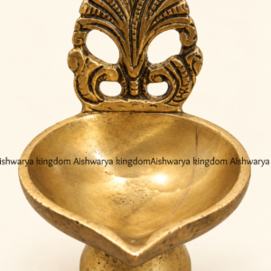 Antique brass diya brass oil lamp with carved leaf back and round stand