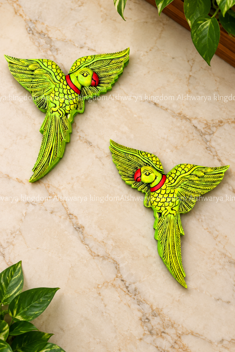 Wooden parrot wall hanging in green and red on a marble wall